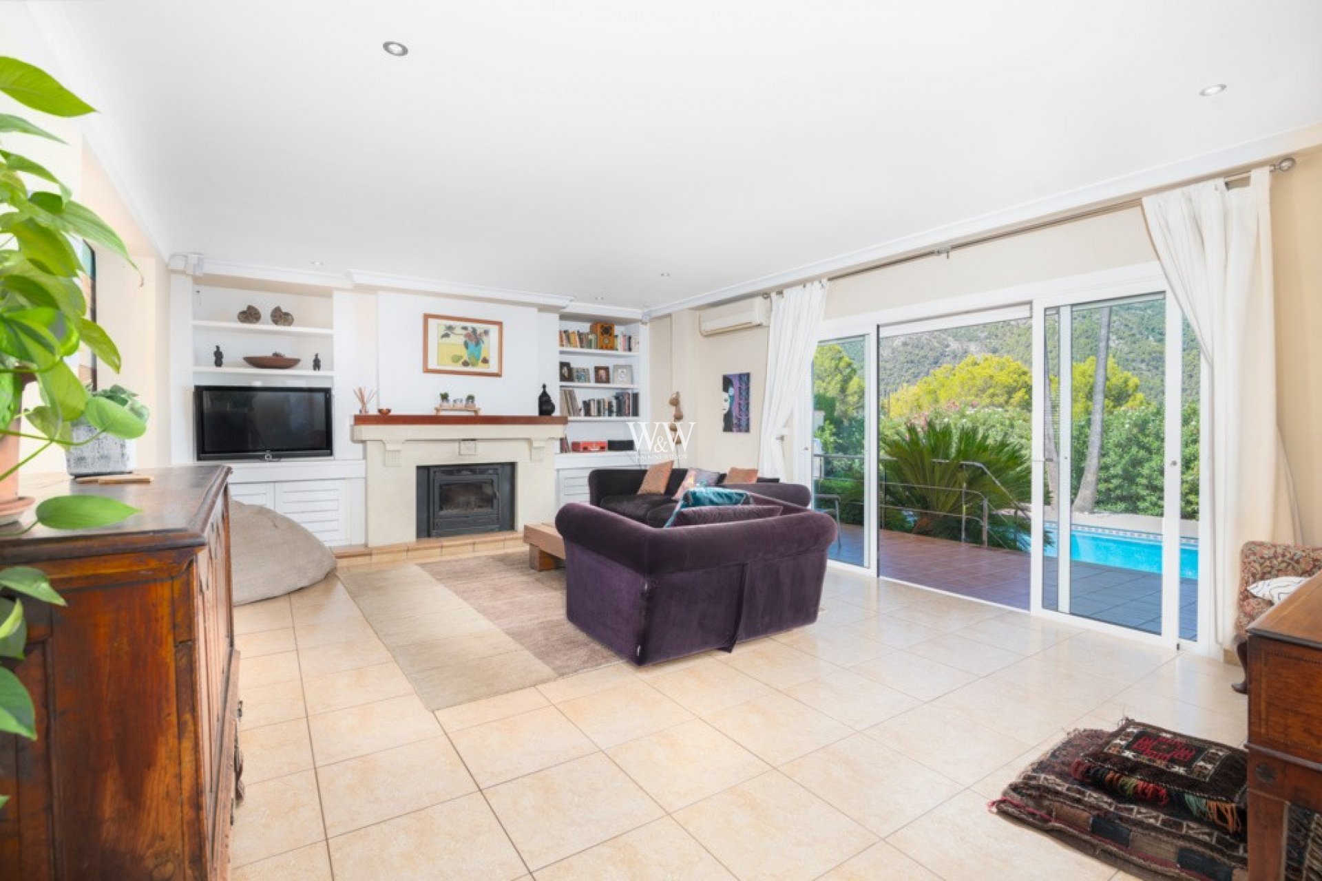 Large sitting room with fireplace and patio doors