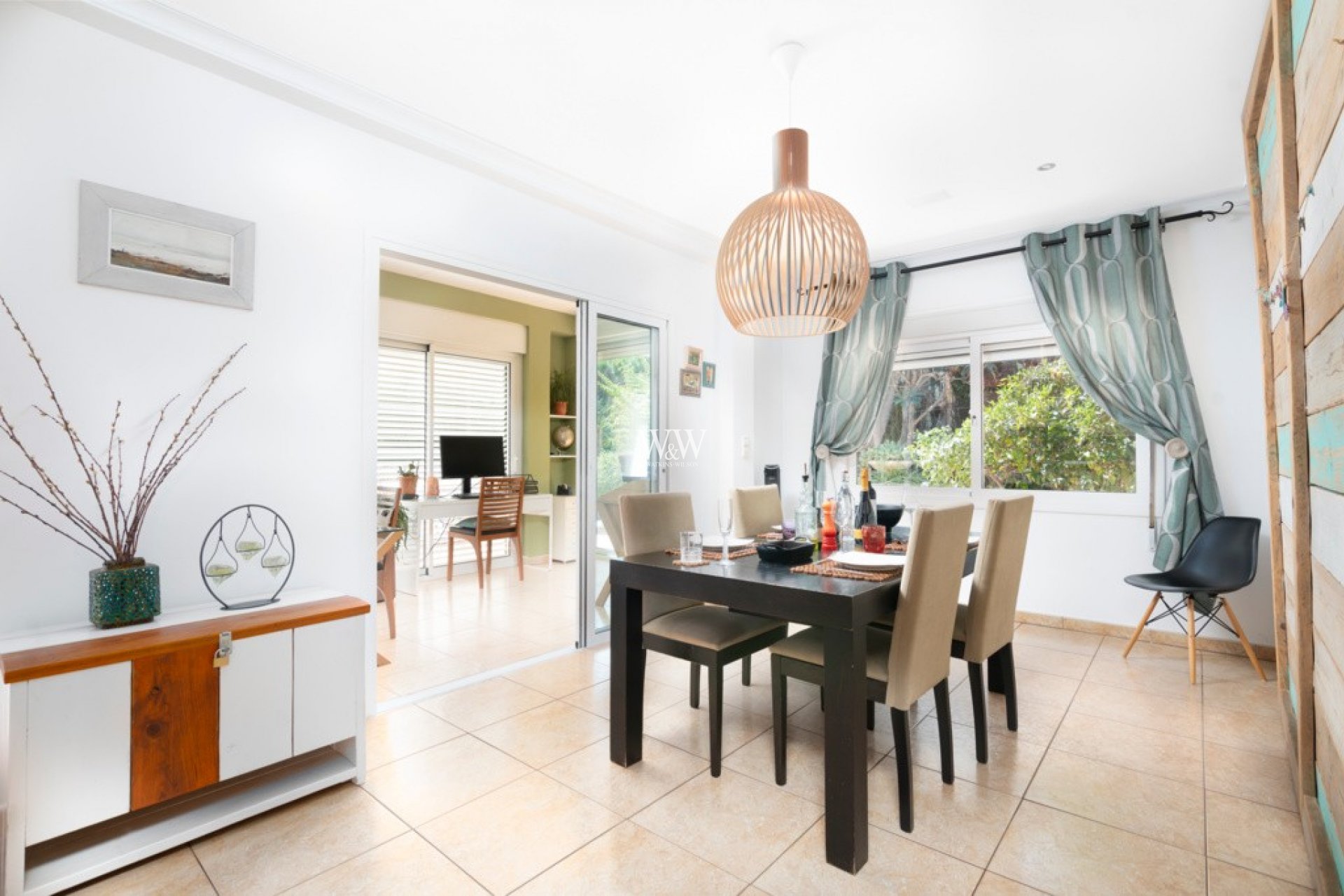 The dining room with sliding door to the lounge and open to the kitchen