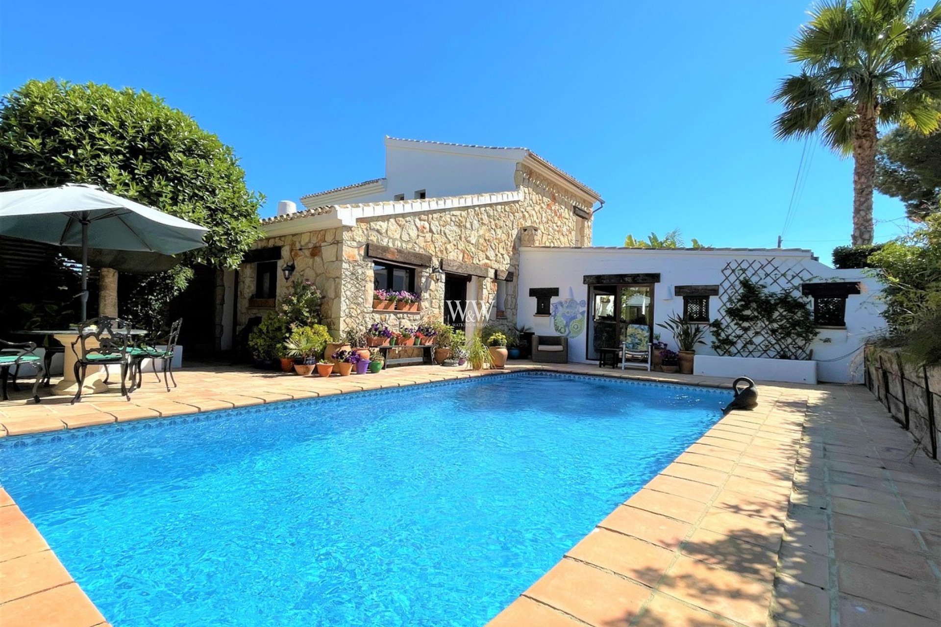 View over the pool to finca style house