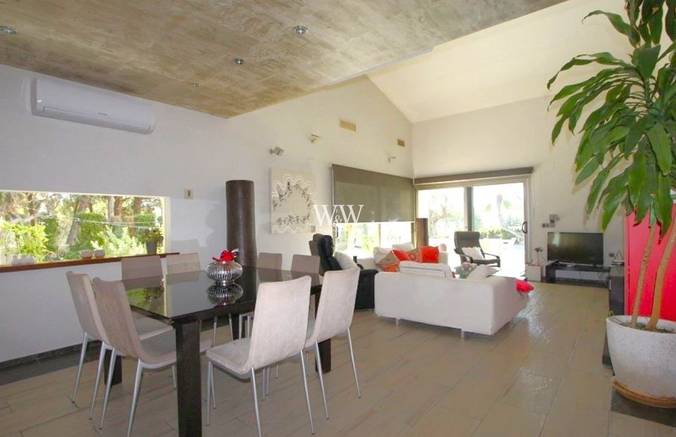 Open plan living area with high ceiling