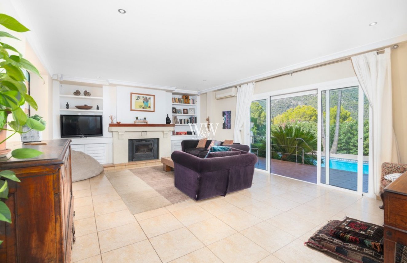 Large sitting room with fireplace and patio doors